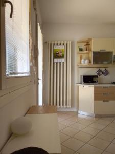a room with a kitchen with a radiator and a table at Casa al parco in Romano D'Ezzelino