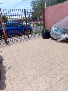 a patio with a fence and a tiled floor at House near AIFA in San Cristóbal