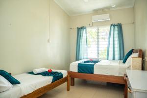 a room with two beds and a window at seaview apartment in Honiara