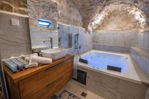 a large bathroom with a tub and a sink at Tirat Ronit - טירת רונית in Safed