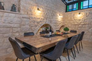 a dining room with a wooden table and chairs at Tirat Ronit - טירת רונית in Safed +26 photos
