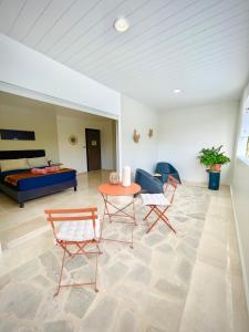 a living room with a table and chairs and a couch at Villa Rose Marie Chambres dhôtes au Calme et Grands Espaces in Le François