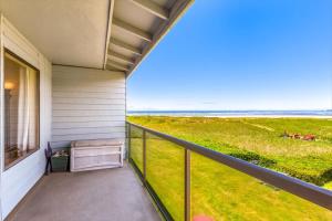 a balcony with a view of the ocean at Hi-Tide Resort Queen Bed Unit 29 in Moclips