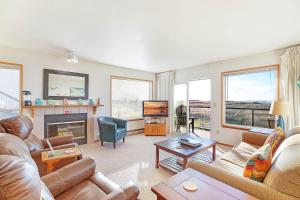 a living room with couches and a tv and a fireplace at Hi-Tide Resort Queen Bed Unit 12 in Moclips +26 photos