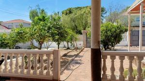 a balcony with a white fence and trees at Finca La Senorita in Molina de Segura