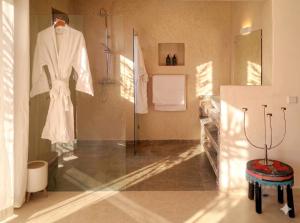 a dressing room with a white robe on a mannequin at Bab Sma in Oumnas +40 photos