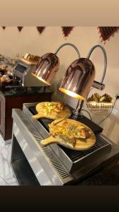 two plates of food on a counter in a kitchen at Wadi Rum Dome Camp in Disah