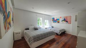 a bedroom with two beds and a window at Luxury Villa by the Lake in Tequesquitengo