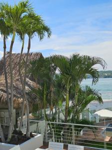 a group of palm trees in front of a resort at Luxury Villa by the Lake in Tequesquitengo