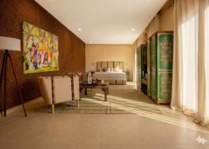 a living room with a bed and a table at Bab Sma in Oumnas