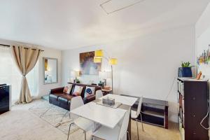 a living room with a couch and a table at City Lights at Newmark - World Cup Availability in Seattle