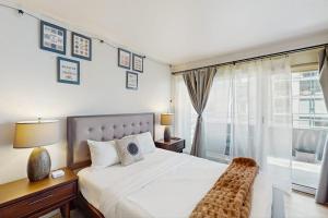 a bedroom with a large bed and a window at City Lights at Newmark - World Cup Availability in Seattle