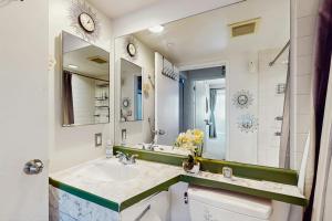 a bathroom with a sink and a mirror at City Lights at Newmark - World Cup Availability in Seattle +5 photos