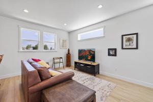 a living room with a couch and a table at Modern Loft Private Golf Course Retreat in Post Falls