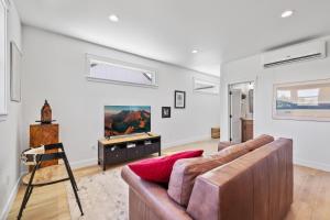 a living room with a couch and a tv at Modern Loft Private Golf Course Retreat in Post Falls +4 photos