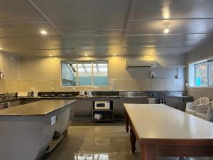 a large kitchen with a table in the middle at Fairlie Holiday Park in Fairlie