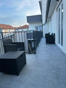 a balcony with chairs and tables on a building at Villa Maria II in Vodice