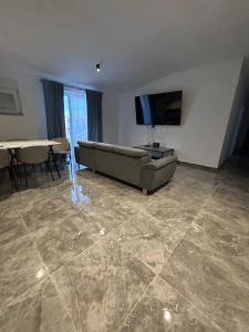 a living room with a couch and a flat screen tv at Villa Maria II in Vodice