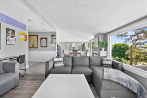 a living room with a couch and a table at Crystal Beach Waterfront Cottage - Sunset Views in Fort Erie