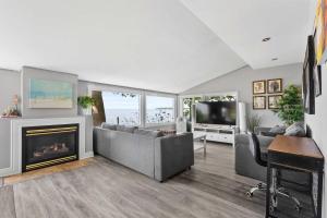 a living room with a fireplace and a tv at Crystal Beach Waterfront Cottage - Sunset Views in Fort Erie