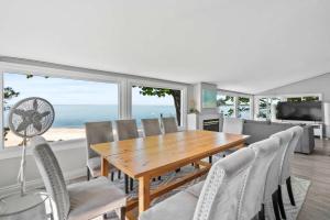 a dining room with a table and chairs at Crystal Beach Waterfront Cottage - Sunset Views in Fort Erie +44 photos