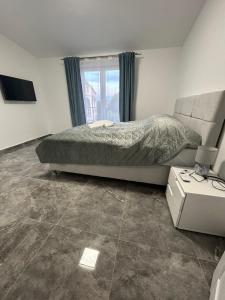 a bedroom with a bed and a window and a television at Villa Maria II in Vodice +3 photos