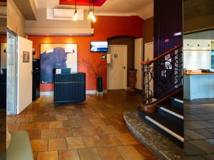 a hallway with a staircase and a painting on the wall at ibis Styles Bayonne in Bayonne