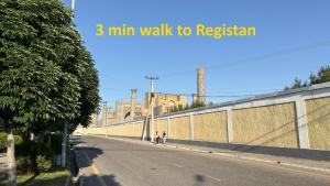 an empty street next to a wall with the words min walk to registration at Private 3BR House 2 Min Walk to Registan in Samarkand