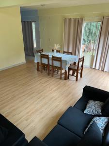 a living room with a table and chairs and a couch at Mango Home - Casa privada con pileta in Puerto Iguazú