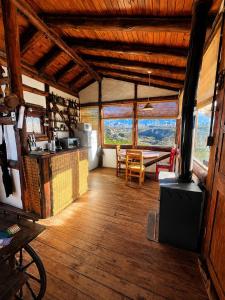 a room with a kitchen and a table in a building at Cabaña El Cóndor in Potrerillos