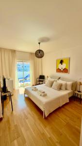 a bedroom with a large white bed in a room at Ilumina Hostel Albufeira in Albufeira