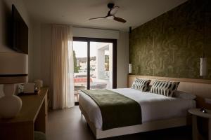a bedroom with a bed and a sliding glass door at Ananda Mojácar - Only Adults in Mojácar +58 photos