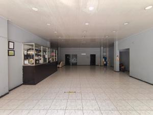 a large room with a tile floor and a large ceiling at Hotel Vegas Sergio in Medellín