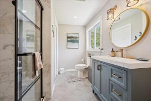 a bathroom with a sink and a mirror at Larkwhistle Sauna Chickens Near BEACHES in Wiarton +32 photos