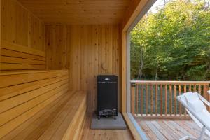 a cabin with a heater on a wooden deck at Private Nordic Spa Retreat - Mont-Tremblant in Lac-Superieur +52 photos