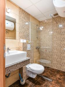 a bathroom with a toilet and a sink and a shower at Boulevard Luxury Apartments City Center Ohrid in Ohrid +72 photos