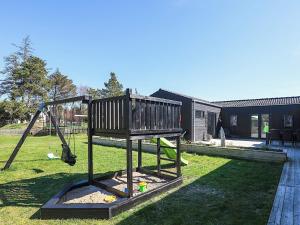 a swing set in the yard of a house at 8 person holiday home in Jerup-By Traum in Jerup