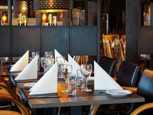 a table in a restaurant with glasses and napkins at Apartment on a holiday park in Blokhus in Blokhus