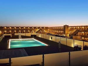 a large building with a swimming pool in front of it at Apartment on a holiday park in Blokhus in Blokhus