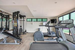 a gym with treadmills and elliptical machines at Plaza Suíte Natal Vista Mar in Natal