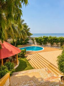 a resort with a swimming pool and the ocean at Kiki bay in Conakry