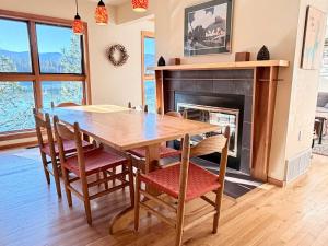 a dining room with a table and chairs and a fireplace at Lake House Private Dock & Decks 4BR in Hayden +24 photos