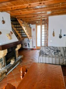 a living room with a bed and a fireplace at Casa vacanze Pievepelago in Pievepelago