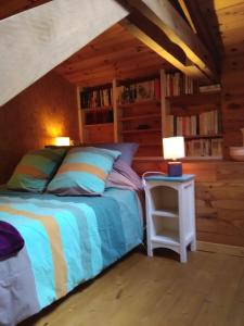 a bedroom with a bed and a table with lamps at Les chambres de Kerael in Crozon