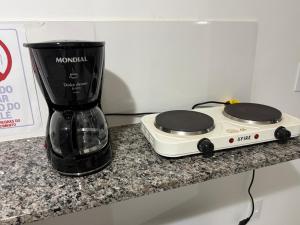 a blender sitting on a counter next to a appliance at Pousada Helena e Heloá in Serra Negra
