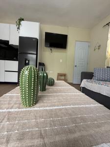 a living room with a table with vases on it at La casita de Polo in Polo
