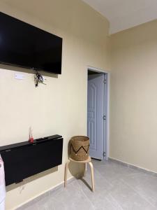 a room with a chair and a tv on the wall at La casita de Polo in Polo