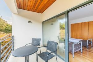 a dining room with a table and chairs on a balcony at HI Alvados - Pousada de Juventude in Alvados