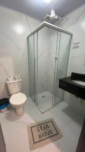 a bathroom with a toilet and a walk in shower at Pousada Ilha do Itacolomi in Penha +11 photos