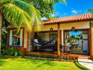 a house with a hammock on the porch at Cantinho do marinheiro in Paraty